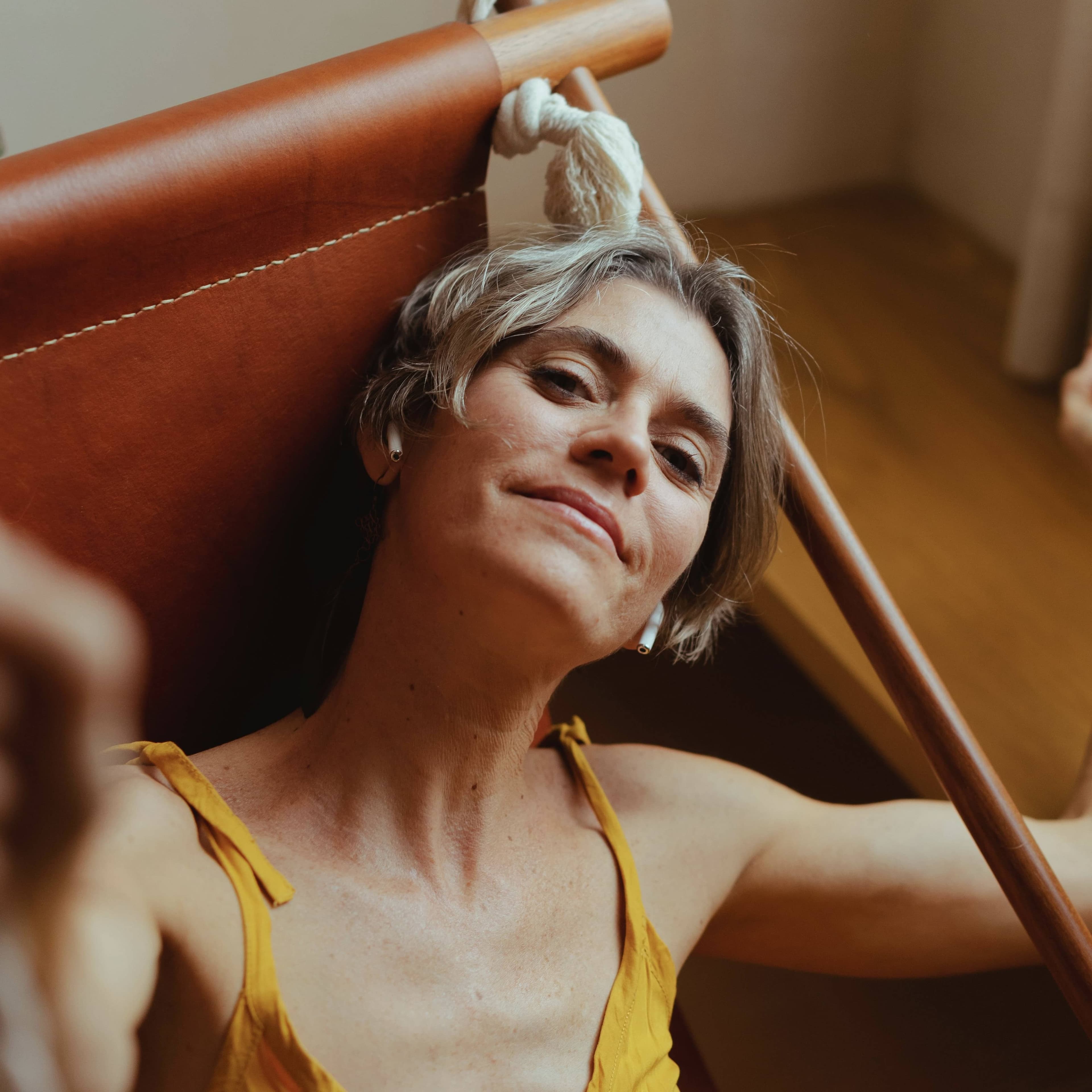 beautiful, mature woman with a knowing smile, symbolizing vitality and wellness with Hormone Replacement Therapy (HRT); ideal representation of menopause relief and anti-aging benefits for women through hormone balance.